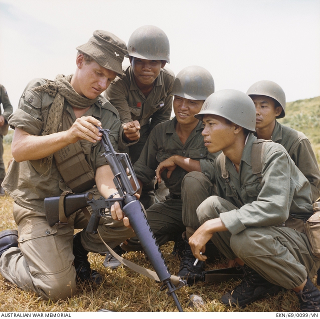 A soldier demonstrates the M16 to ARVN 18th Division troops at the Horseshoe