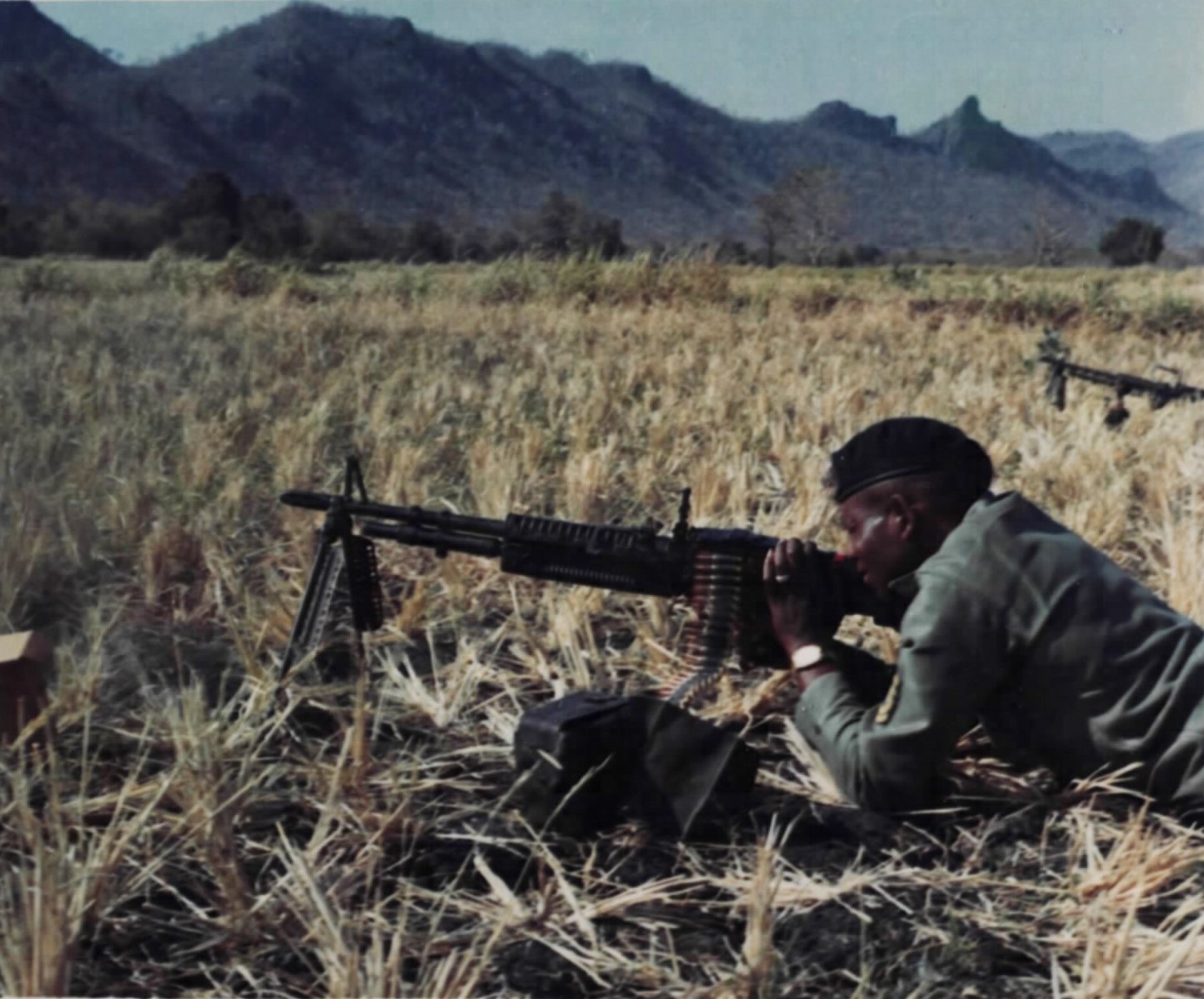 A Special Forces sergeant test-fires an M60 from the prone position