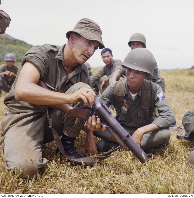 A soldier demonstrates the M79 grenade launcher to ARVN 18th Division troops at the Horseshoe
