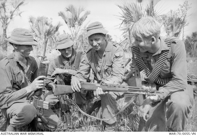 Soldiers examine an SKS rifle captured during Operation Matilda, January 1970