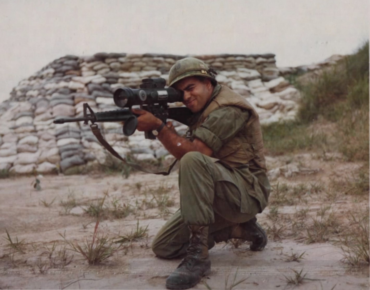 A 9th Infantry Division security guard sights through a Starlight scope mounted on his M16